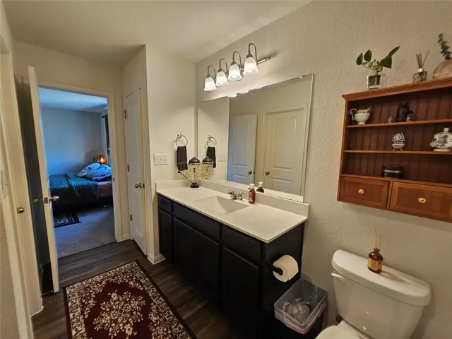 a en suite bathroom with a toilet sink and mirror