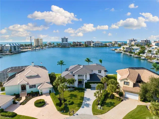 an aerial view of a house with outdoor space and lake view