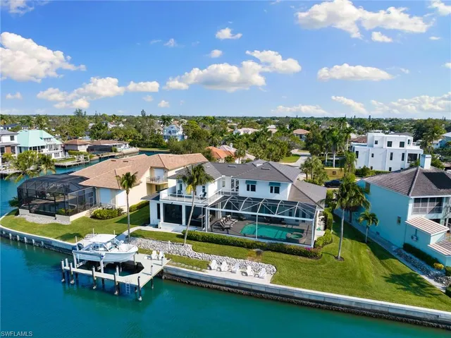 an aerial view of a house with a garden and lake view
