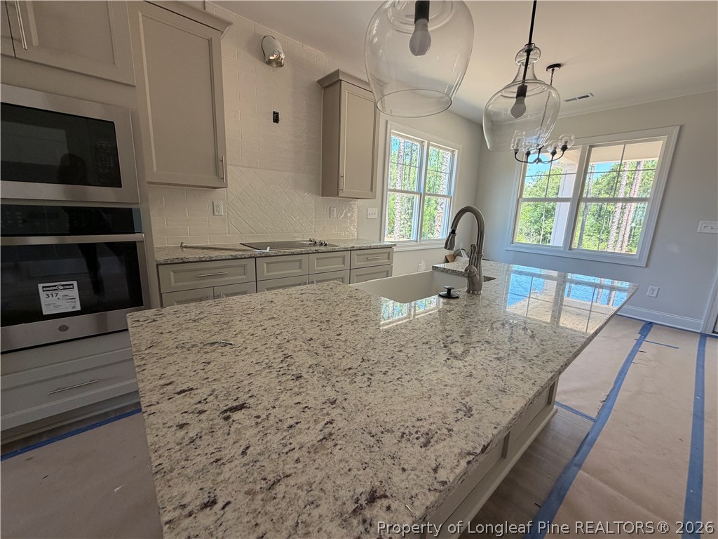 930 Rhum Drive Fayetteville, NC 28311 - Photo 14 of 49 a kitchen with a sink a counter top space cabinets and stainless steel appliances