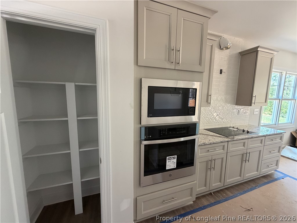 930 Rhum Drive Fayetteville, NC 28311 - Photo 16 of 49 a kitchen with stainless steel appliances granite countertop a stove microwave and cabinets