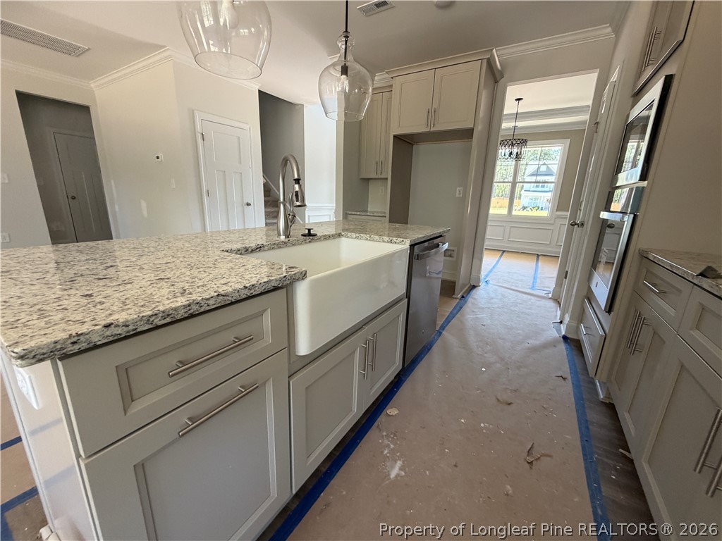 930 Rhum Drive Fayetteville, NC 28311 - Photo 19 of 49 a large kitchen with a granite countertop sink a refrigerator a washer and dryer