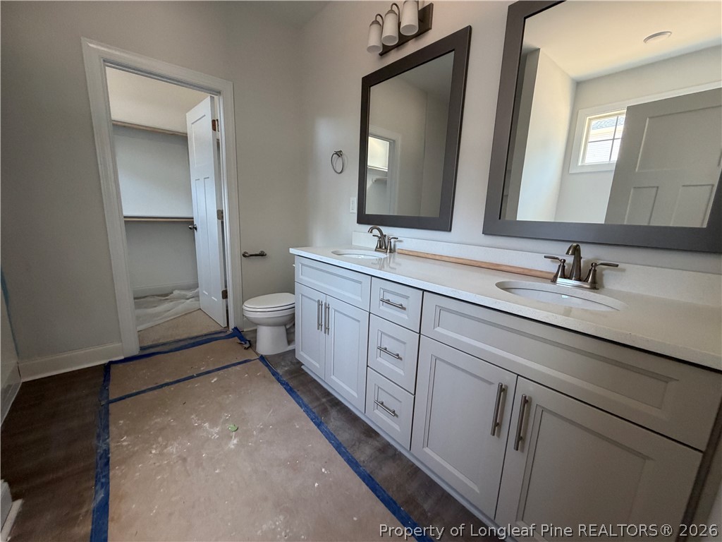 930 Rhum Drive Fayetteville, NC 28311 - Photo 26 of 49 a spacious bathroom with a double vanity sink and mirror