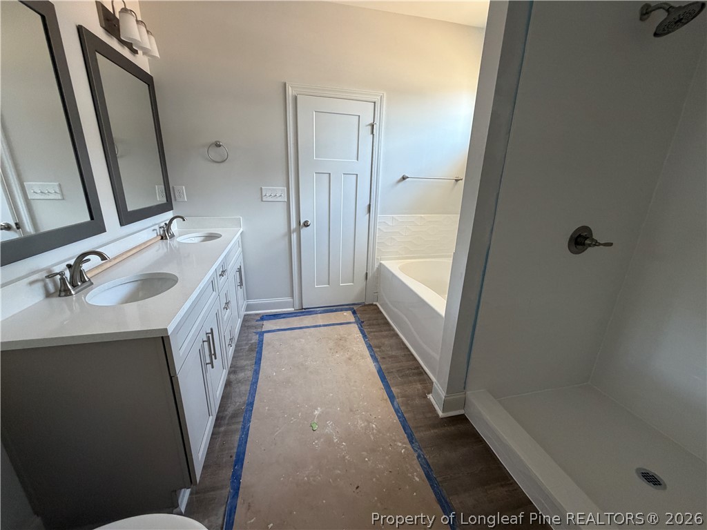 930 Rhum Drive Fayetteville, NC 28311 - Photo 31 of 49 a bathroom with sink a mirror a bathtub and shower