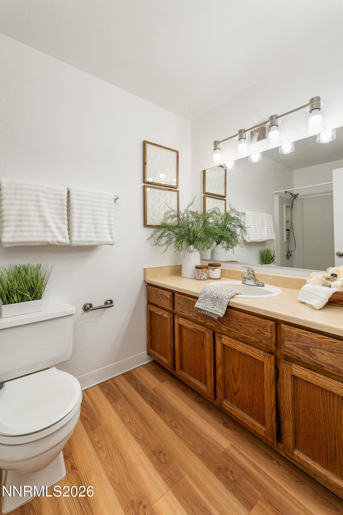 1465 East Peckham Lane, Unit 6 Reno, NV 89502 - Photo 12 of 25 a spacious bathroom with a double vanity sink toilet and a mirror