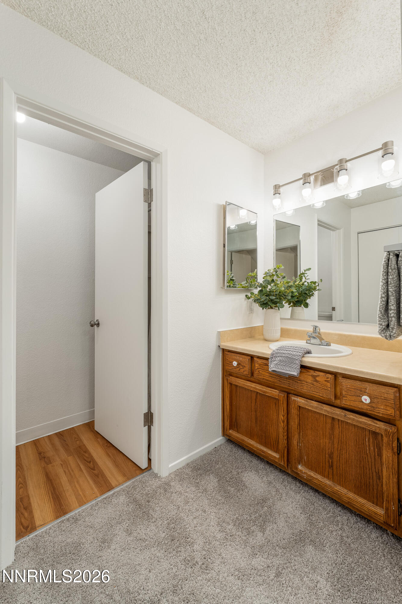 1465 East Peckham Lane, Unit 6 Reno, NV 89502 - Photo 15 of 25 a spacious bathroom with a granite countertop sink and a mirror