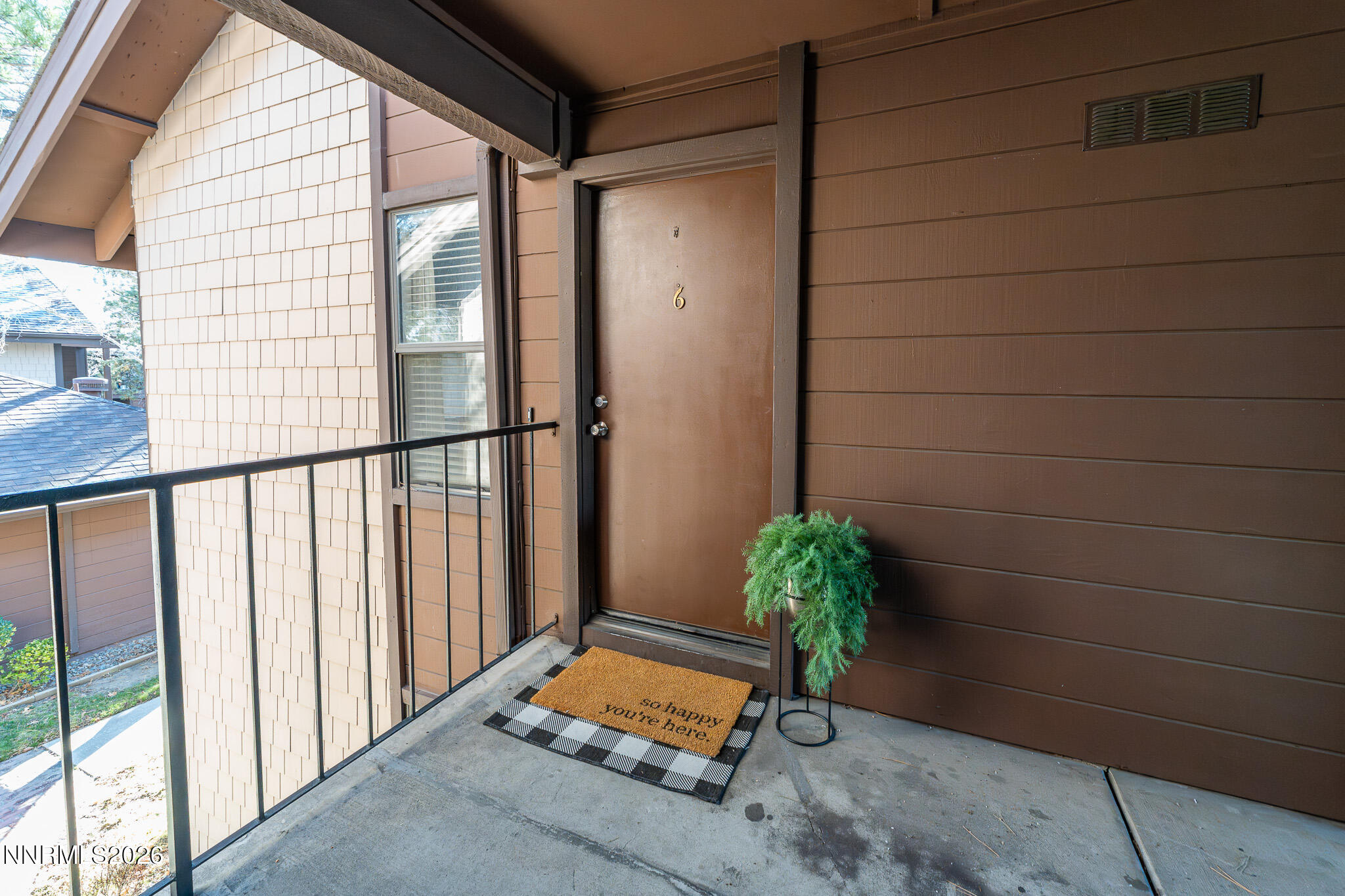 1465 East Peckham Lane, Unit 6 Reno, NV 89502 - Photo 17 of 25 a view of a porch with a bench