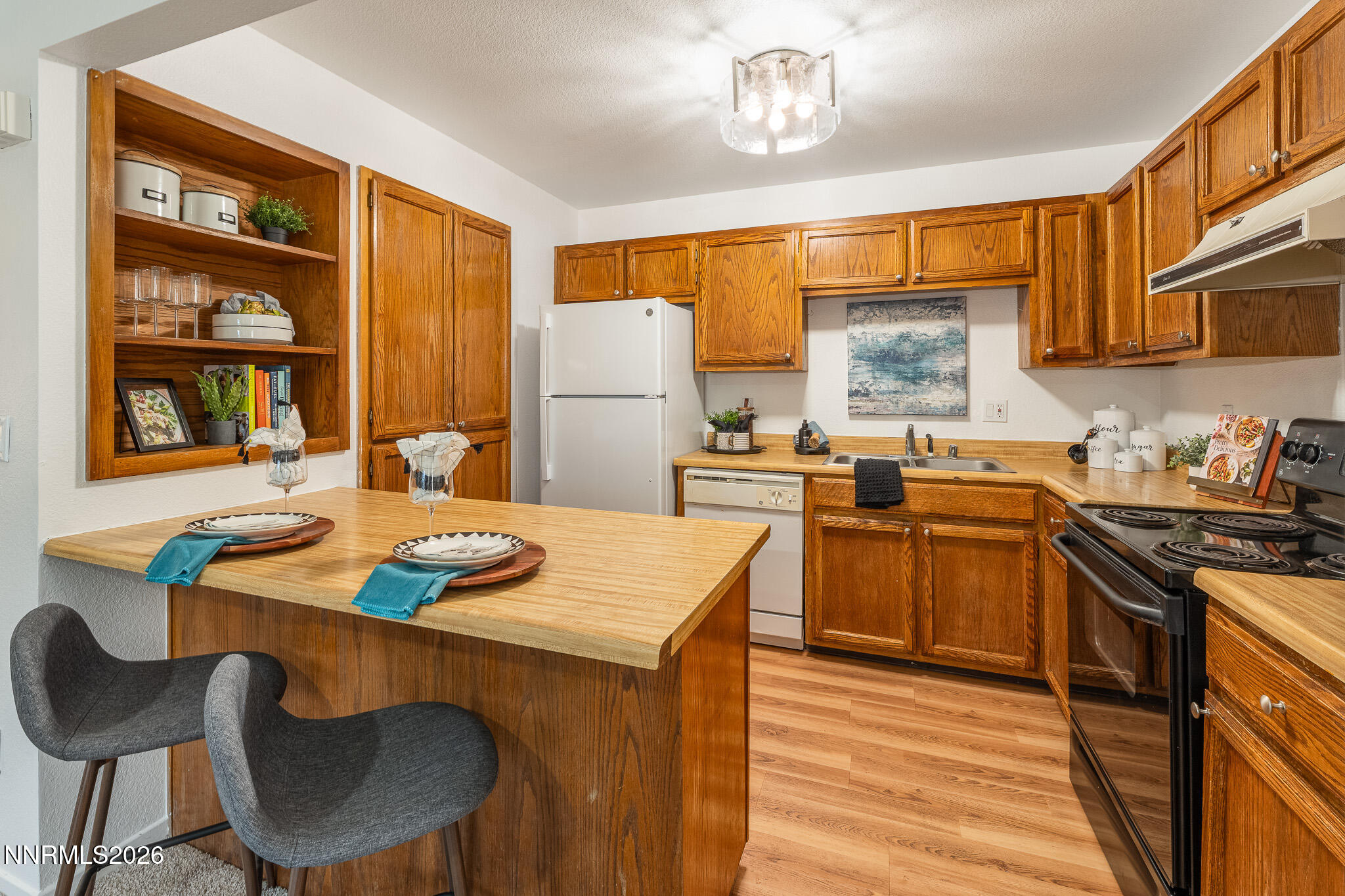 1465 East Peckham Lane, Unit 6 Reno, NV 89502 - Photo 5 of 25 a kitchen with a table chairs stove and refrigerator