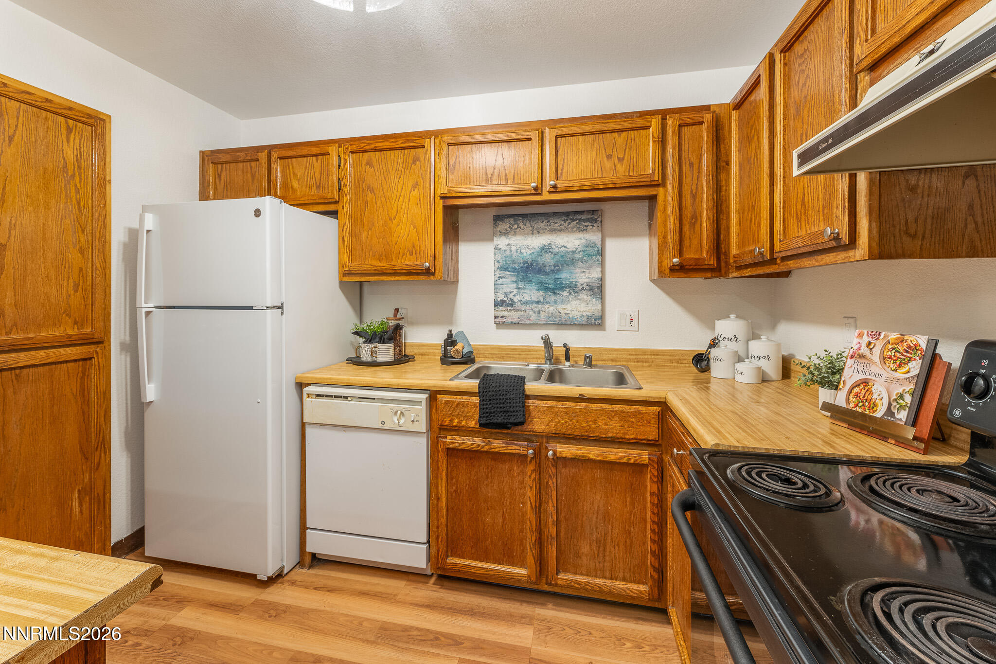 1465 East Peckham Lane, Unit 6 Reno, NV 89502 - Photo 6 of 25 a kitchen with a refrigerator and a stove