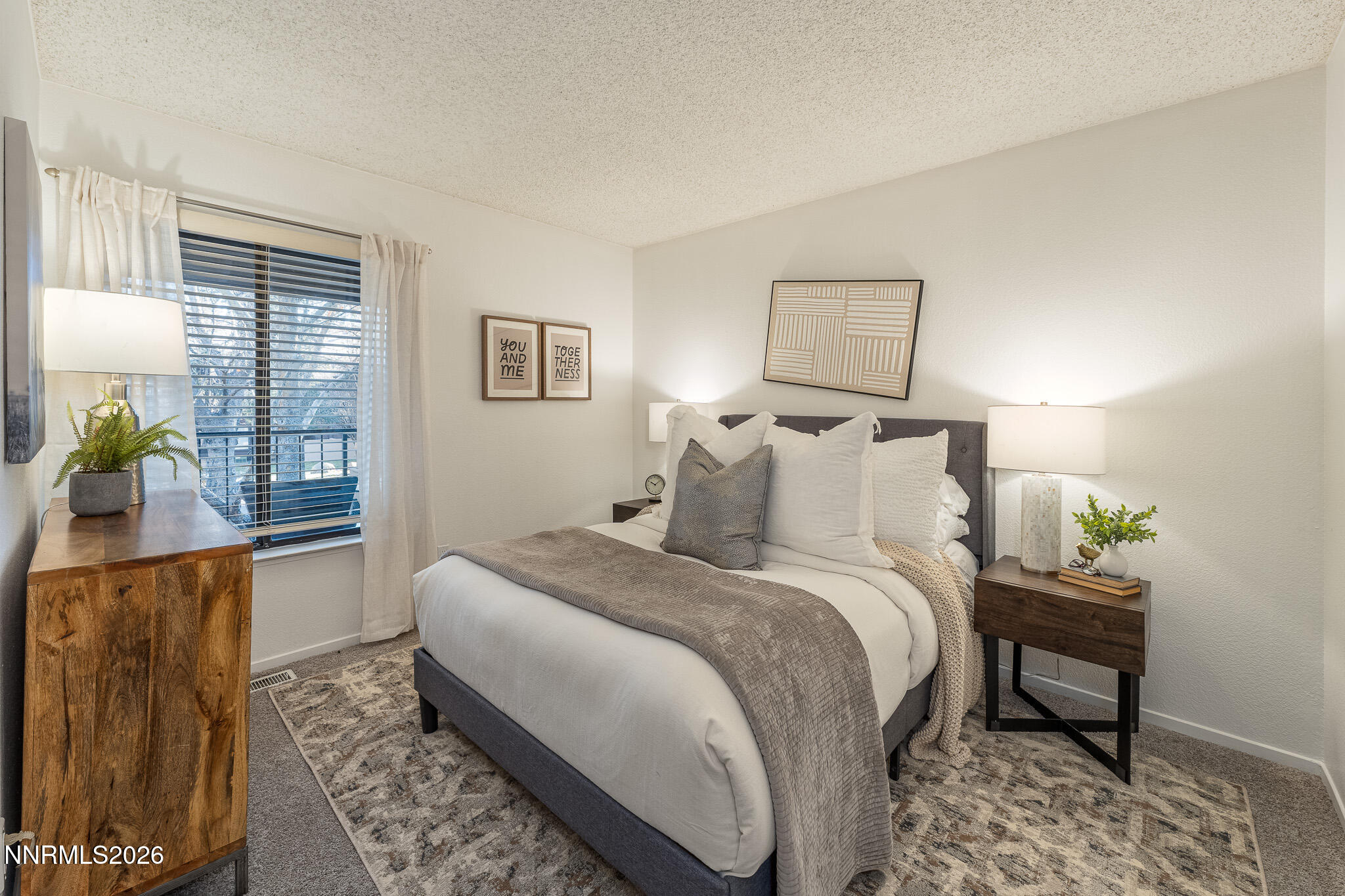 1465 East Peckham Lane, Unit 6 Reno, NV 89502 - Photo 8 of 25 a bedroom with bed and a potted plant