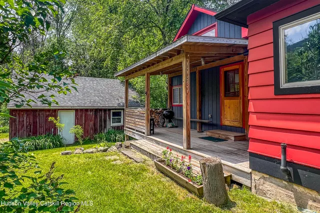 a front view of house with yard and outdoor seating