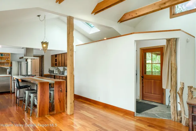 a view of a kitchen with furniture and wooden floor