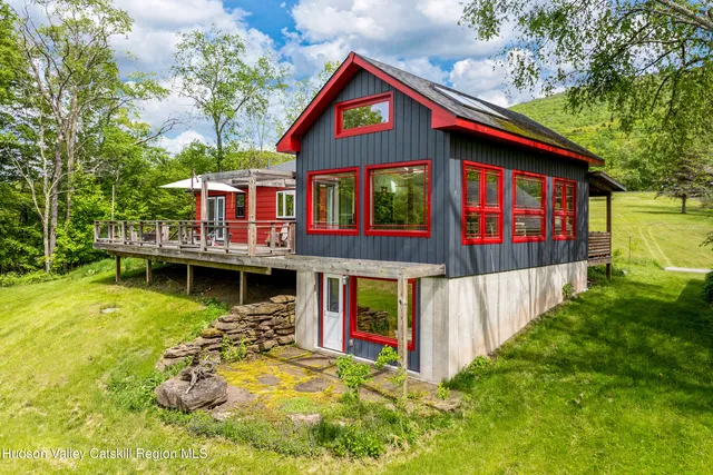 a view of a house with pool and chairs