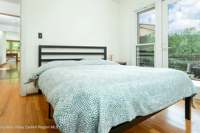 a large bed sitting in a bedroom next to a window