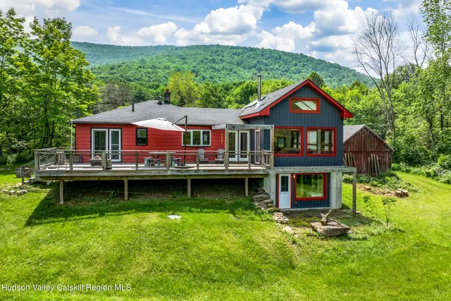 a view of a house with a yard in front of it