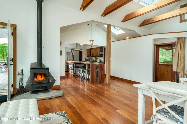 a view of a balcony with chairs and wooden floor