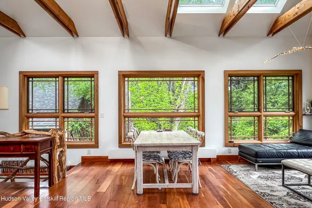 a dining room with furniture window and wooden floor
