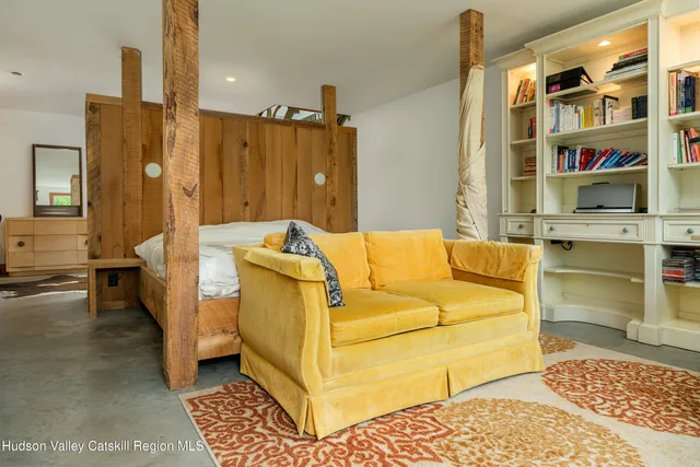 a bedroom with a large bed and a large window