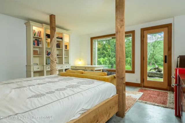 a view of a bedroom with bathroom and shower