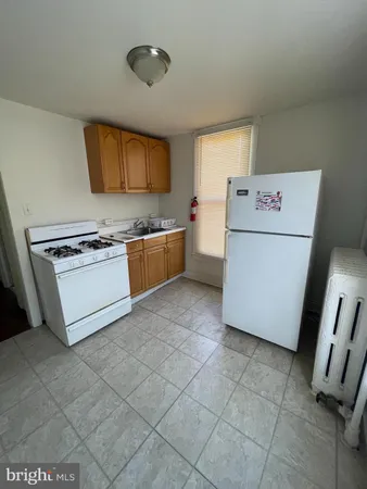 a kitchen with a stove a sink and a refrigerator