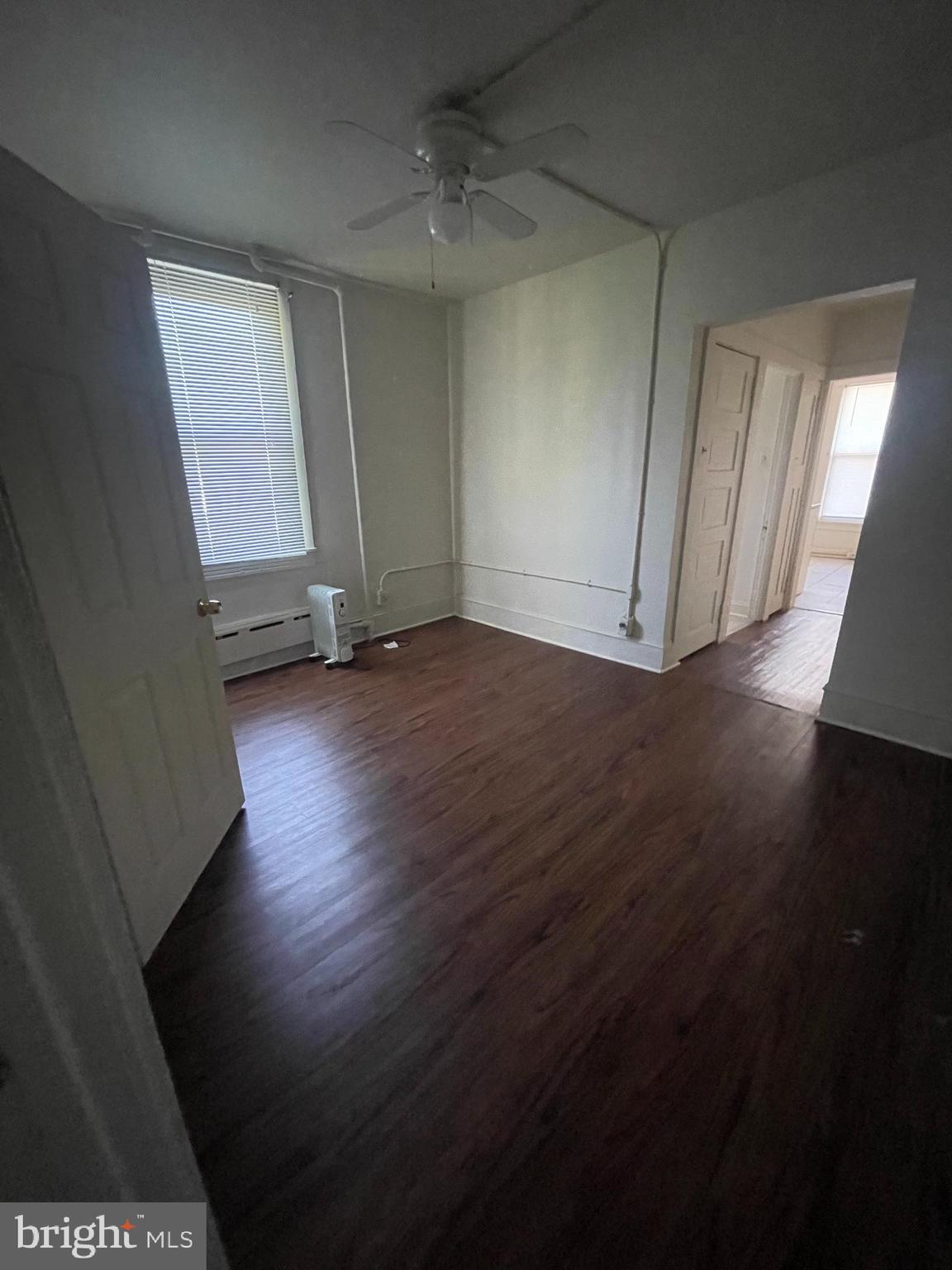 13 Kirkwood Road, Unit 2B Gibbsboro, NJ 08026 - Photo 7 of 9 an empty room with wooden floor and windows