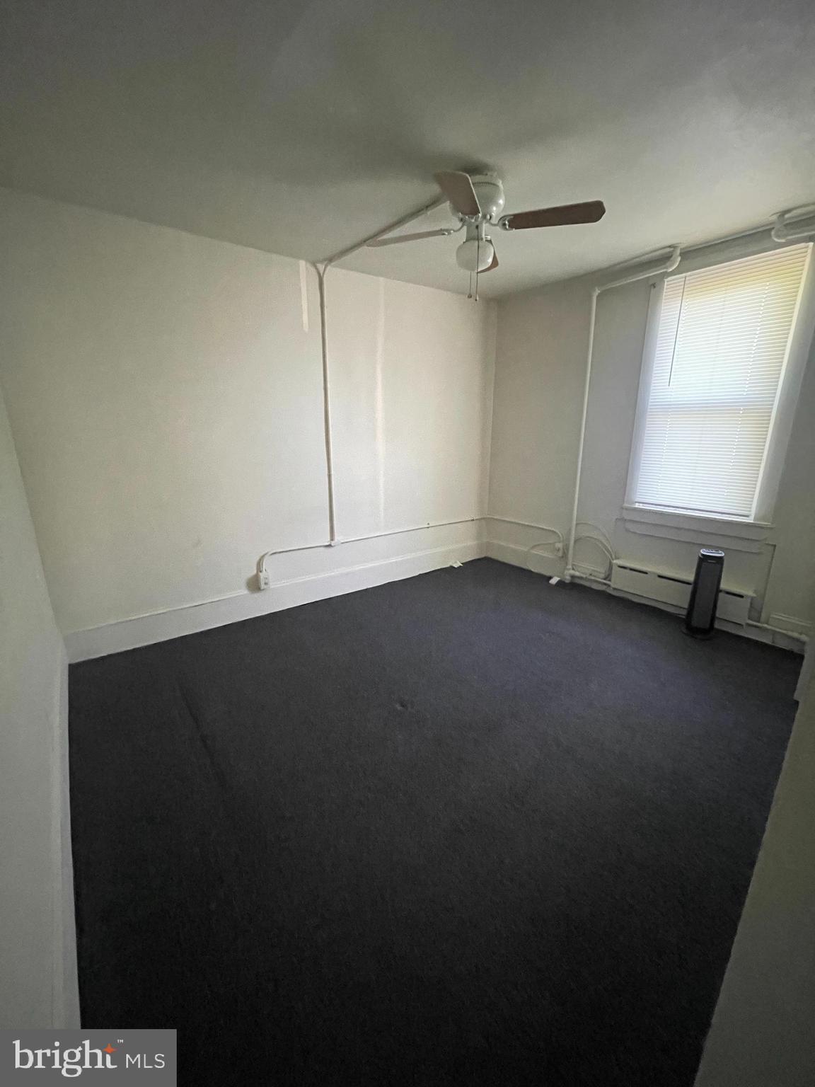 13 Kirkwood Road, Unit 2B Gibbsboro, NJ 08026 - Photo 8 of 9 an empty room with a ceiling fan and a window