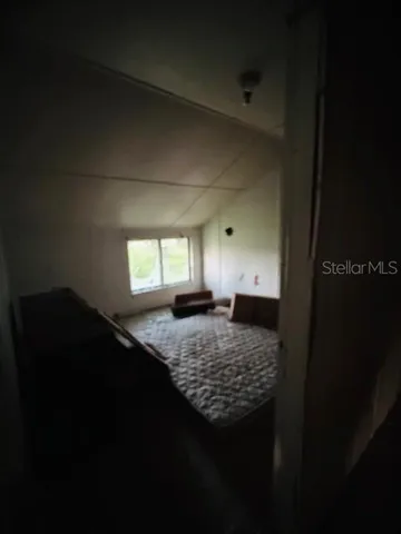 a bedroom with a bed and window