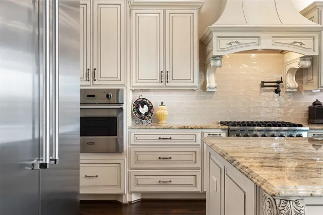 a kitchen with stainless steel appliances granite countertop a stove and a sink