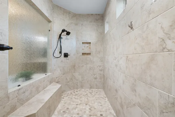 a bathroom with a granite countertop double vanity sink and a mirror