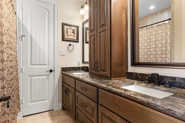 a view of a patio with couches table and chairs under an umbrella