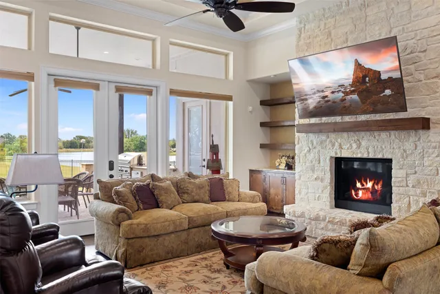 a living room with furniture and a chandelier