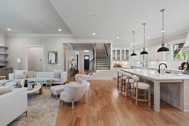 a bedroom with a large bed and a flat tv screen on dresser