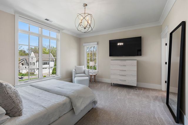 a view of a house with a big yard plants and large trees