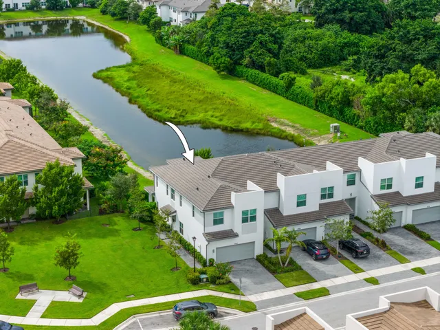 an aerial view of multiple houses with yard