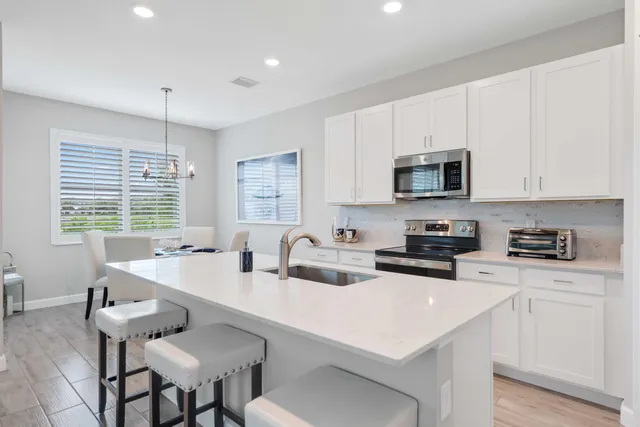 a kitchen with appliances a sink and cabinets