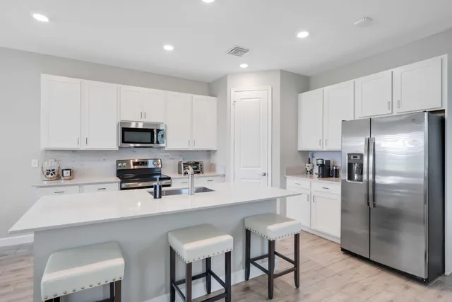 a kitchen with stainless steel appliances a stove a sink a stove and cabinets