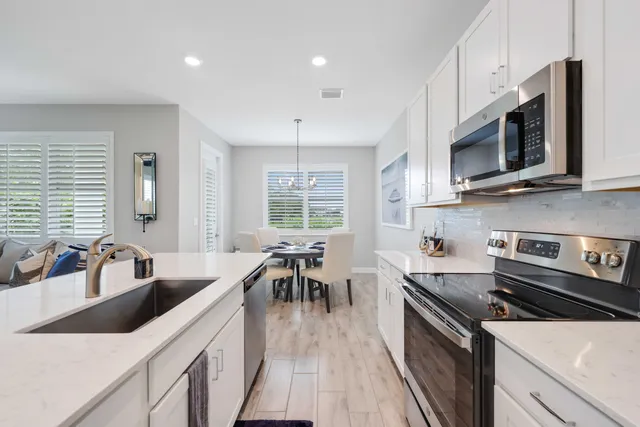 a view of living room with furniture a flat screen tv and a rug
