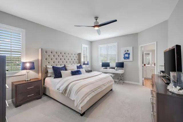 a bathroom with a sink a toilet a mirror and shower