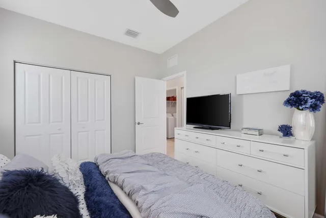 a bedroom with a bed and a chandelier