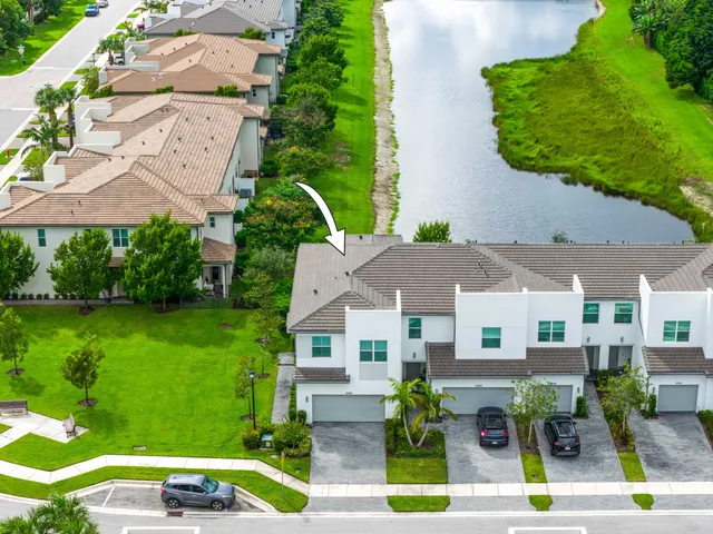 an aerial view of a house with a garden and lake view