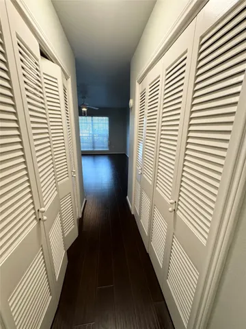 a view of a hallway with wooden floor