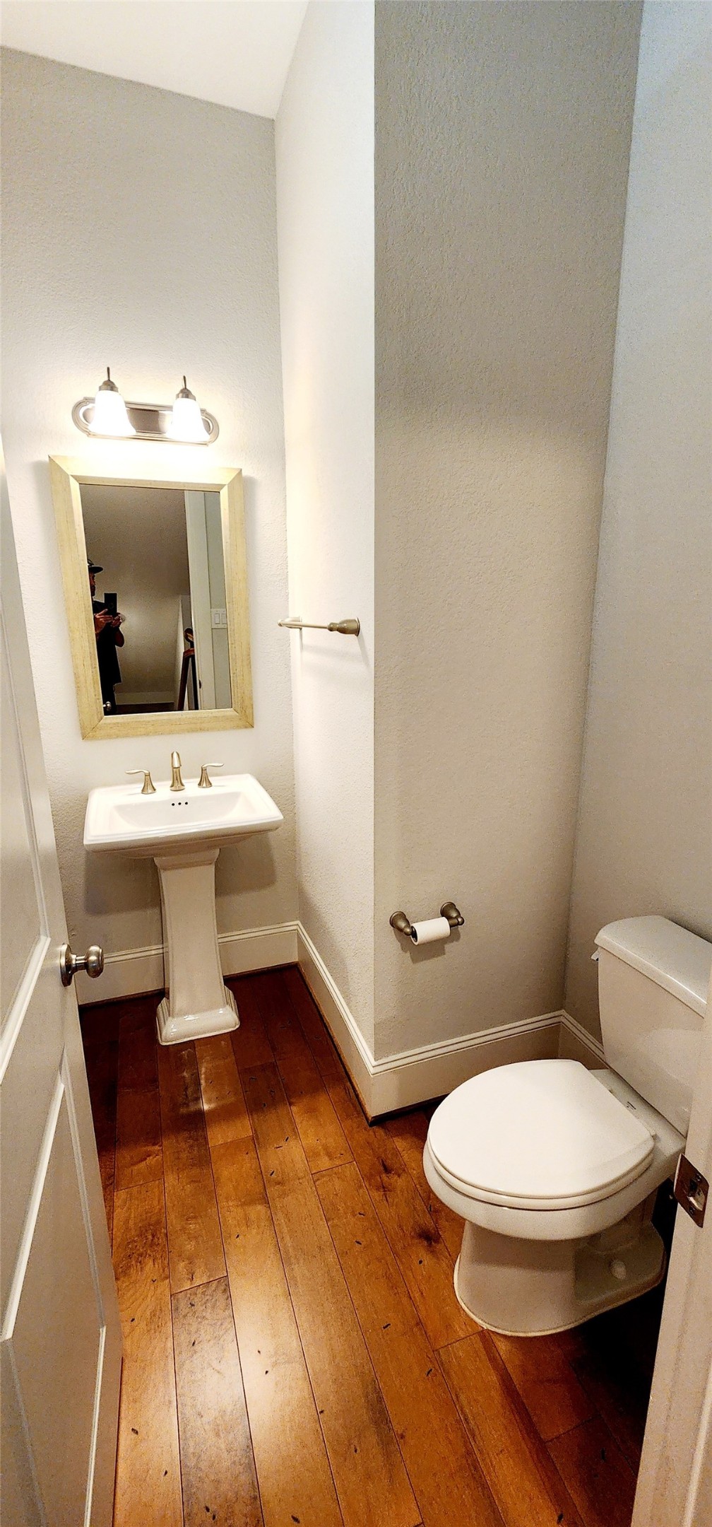 11 West Rafters Row The Woodlands, TX 77380 - Photo 9 of 31 a bathroom with a toilet sink and mirror