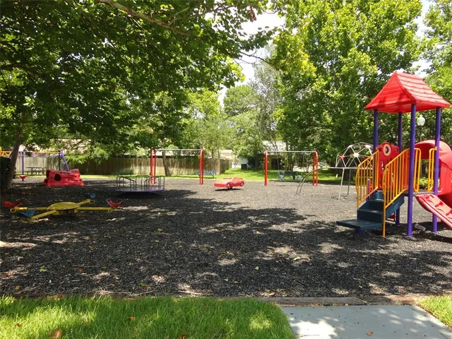 a childrens park with lots of swings and slides
