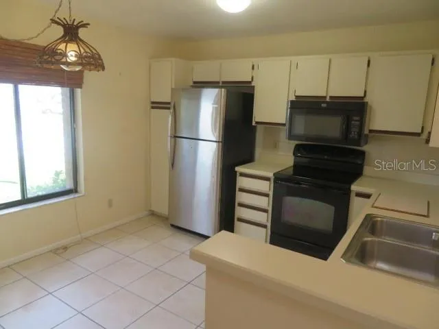 a kitchen with a refrigerator sink and microwave