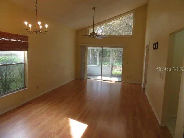 a view of a room with wooden floor and window
