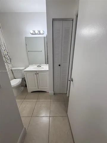 a bathroom with a granite countertop sink and mirror