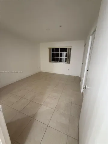 an empty room with a empty space and windows