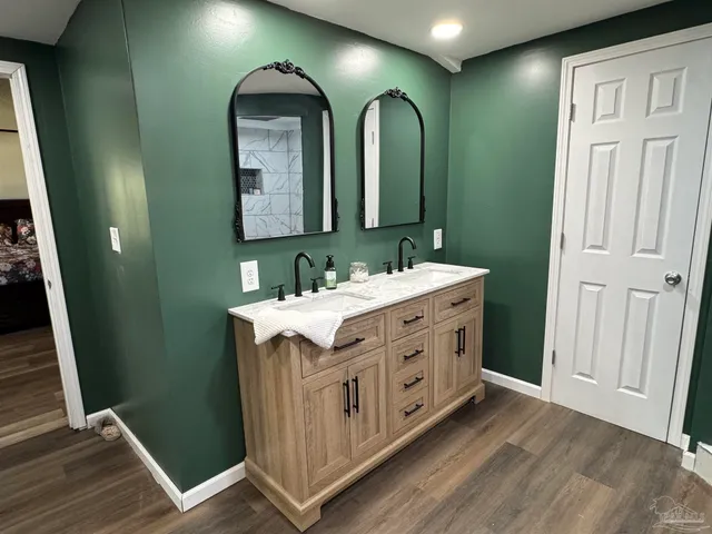 a bathroom with a double vanity sink and a mirror