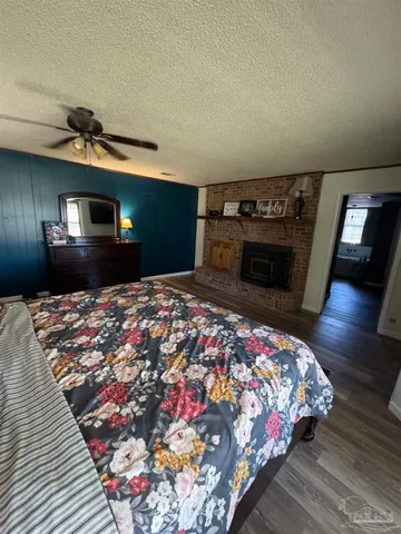 a bedroom with bed and a fireplace