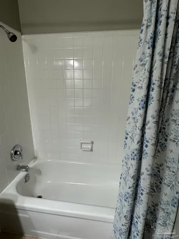 a bathroom with a bathtub and shower